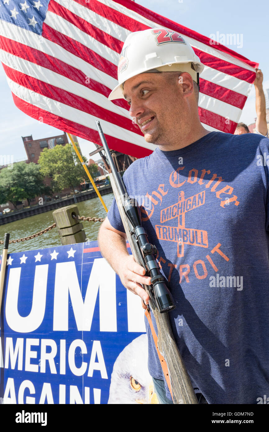 Cleveland, Ohio, USA. 18th July, 2016. A Trump supporter stands holding a hunting rifle during a rally near the Republican National Convention at the Quicken Loans Center July 18, 2016 in Cleveland, Ohio. Credit:  Planetpix/Alamy Live News Stock Photo