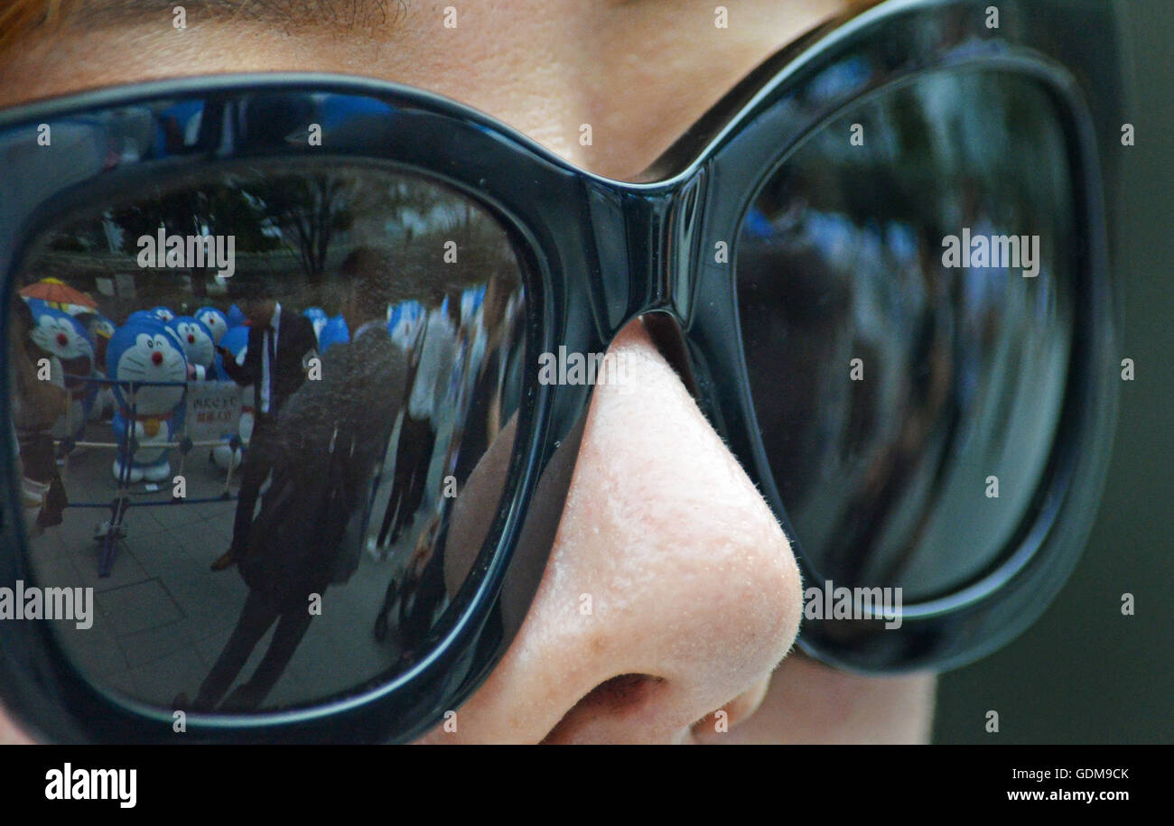 Tokyo, Japan. 14th July, 2016. A glasses reflection of anime figure and