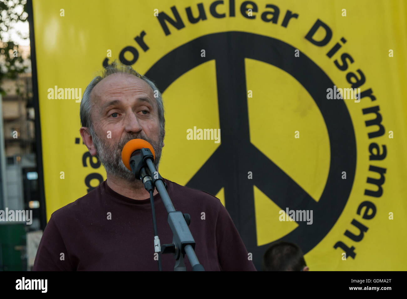 London, UK. 18th July 2016.   A speaker for Left Unity at the emergency protest organised by CND outside Parliament as the debate over the Trident replacement was taking place. The replace would cost over £200 billion, and the weapons have no strategic value and will almost certainly be obsolete  before they are brought into service. Protesters say their use would be illegal, totally immoral and their use would have a devastating effect on life on earth. Credit:  Peter Marshall/Alamy Live News Stock Photo