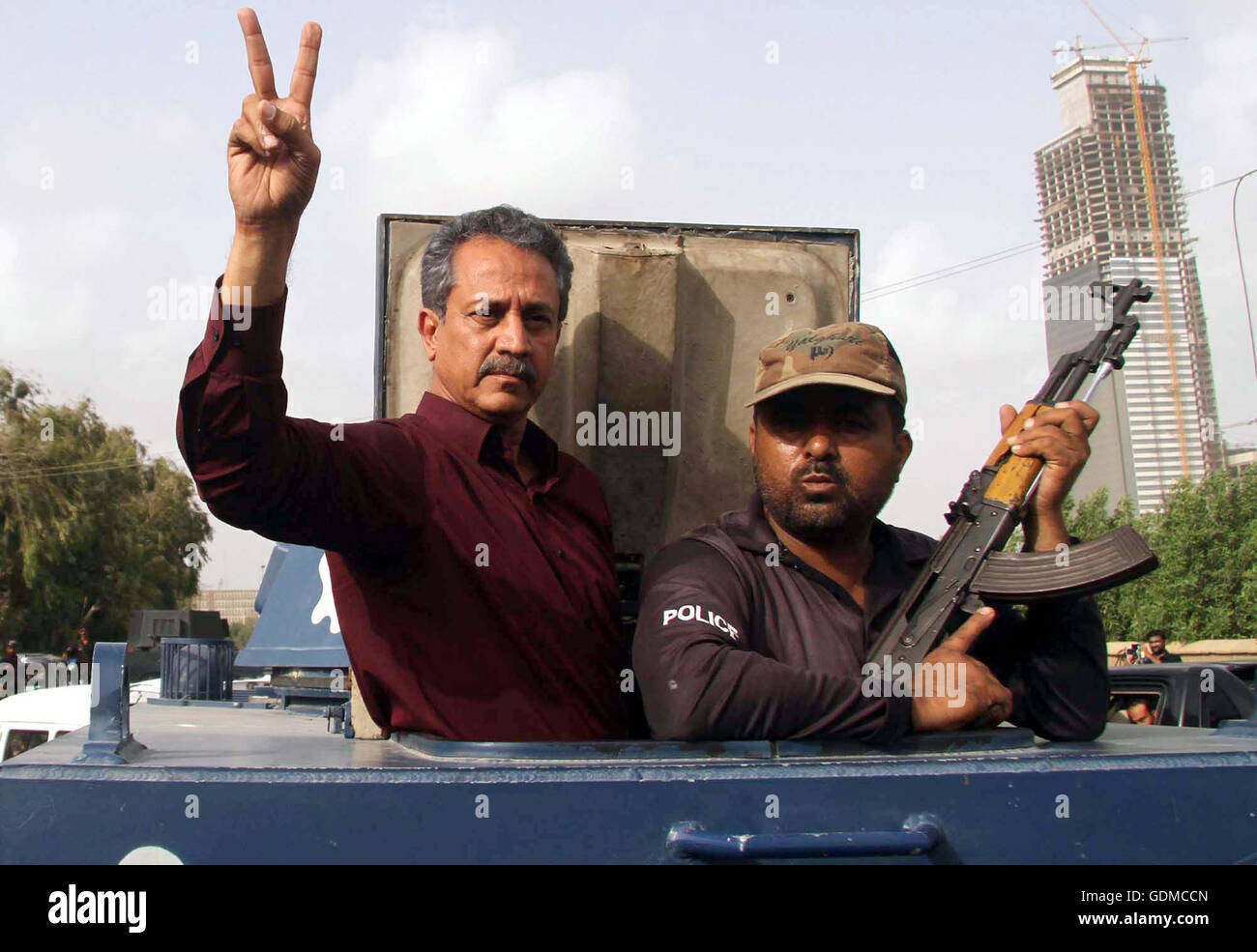 Muttahida Qaumi Movement leader Wasim Akhtar makes victory sign as he is being shifted to Karachi's Central Prison in a police van after rejected his interim bail in a terror facilitation case at an anti-terrorism court (ATC) in Karachi on Tuesday, July 19, 2016. Muttahida Qaumi Movement (MQM) leaders Wasim Akhtar and Rauf Siddiqui, and Pak Sarzameen Party president Anis Qaimkhani were taken into custody in a terror facilitation case after an anti-terrorism court (ATC) rejected their interim bail. Stock Photo