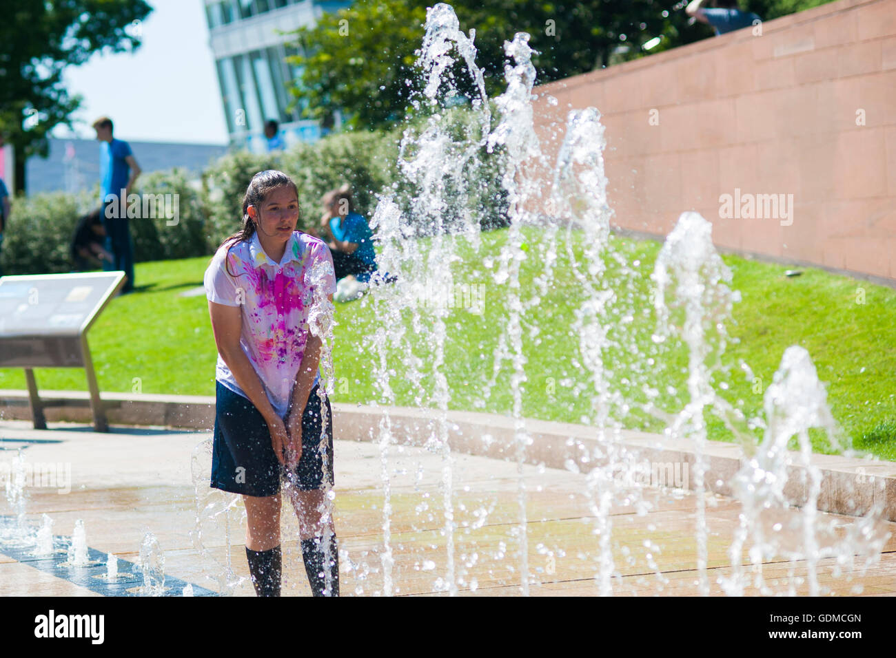 Liverpool, UK, 19th July 2016. A schoolgirl about to run into a water fountain to cool down on the hottest day of the year. Credit:  Hayley Blackledge/Alamy Live News Stock Photo