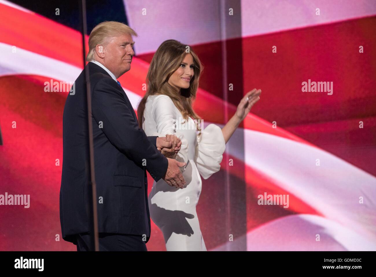 GOP presidential nominee Donald Trump escorts his wife Melania Trump off stage following her address during the first day of the Republican National Convention at the Quicken Loans Center July 18, 2016 in Cleveland, Ohio. Stock Photo