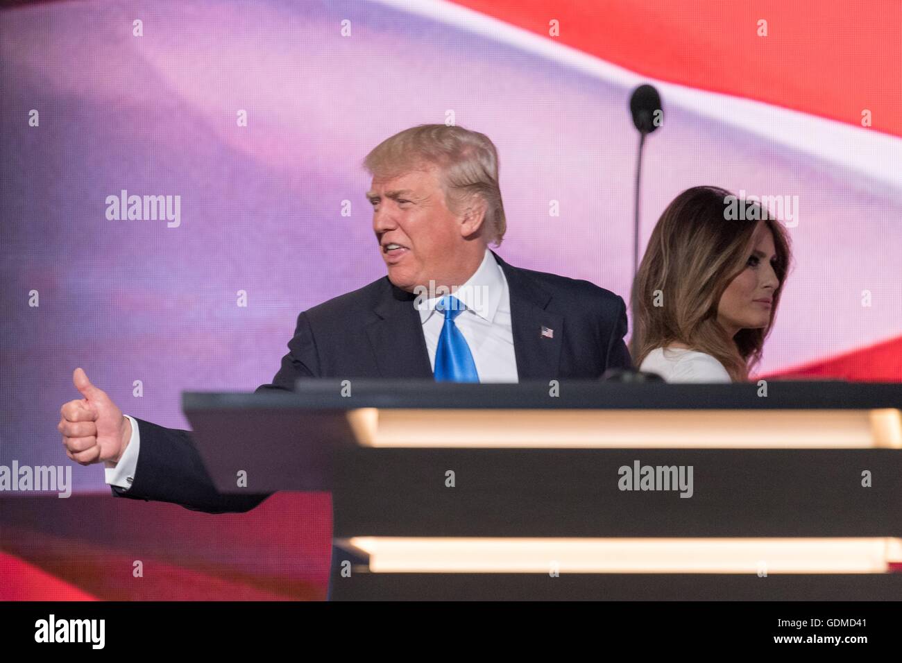 GOP presidential nominee Donald Trump gives a thumbs as he escorts his wife Melania Trump following her address during the first day of the Republican National Convention at the Quicken Loans Center July 18, 2016 in Cleveland, Ohio. Stock Photo