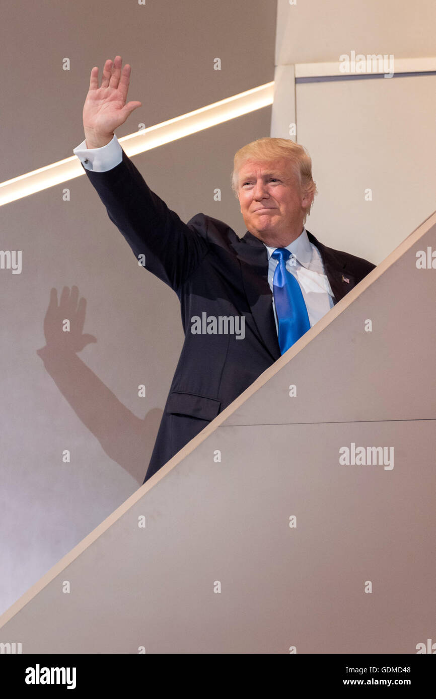GOP Presidential nominee Donald Trump waves as he walks off stage following his wife Melania's address during the first day of the Republican National Convention at the Quicken Loans Center July 18, 2016 in Cleveland, Ohio. Stock Photo
