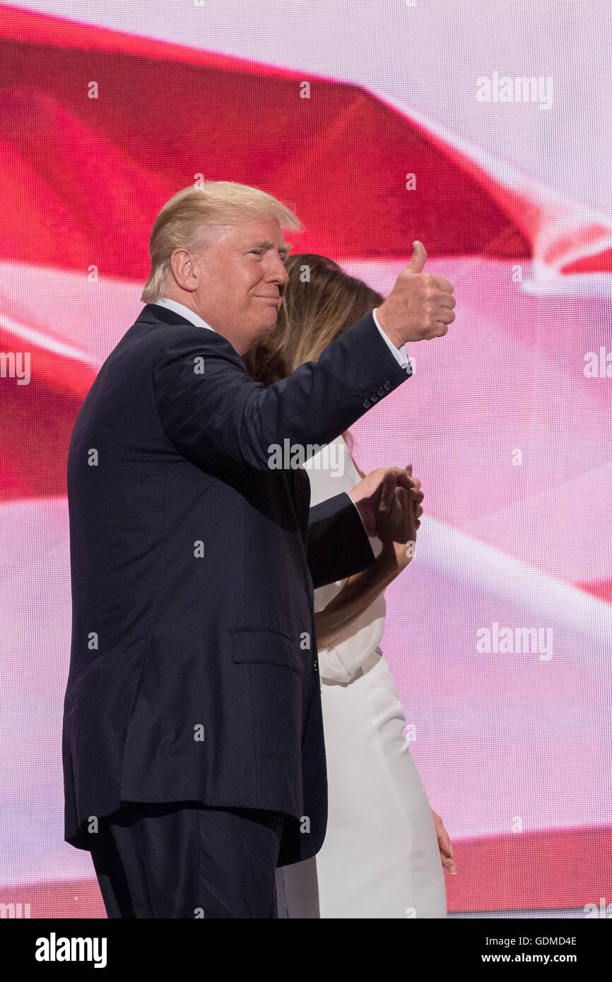 Donald Trump gives a thumbs up as he escorts his wife Melania Trump off stage following her address during the first day of the Republican National Convention at the Quicken Loans Center July 18, 2016 in Cleveland, Ohio. Stock Photo