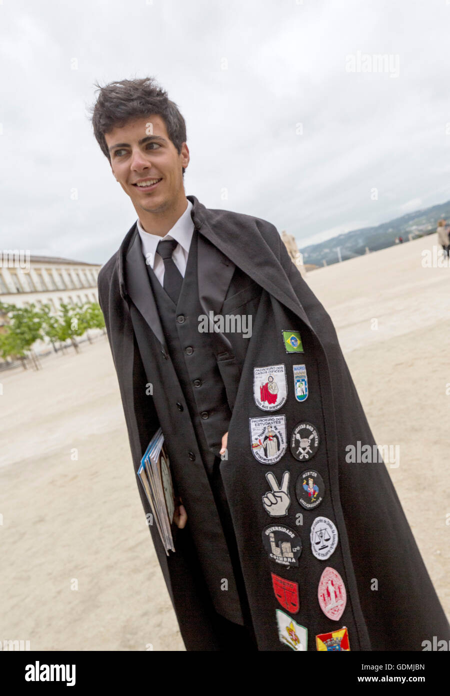 Student with Black Cape at the University of Coimbra, stickers with  different meanings on the capes of the students of Coimbra Stock Photo -  Alamy