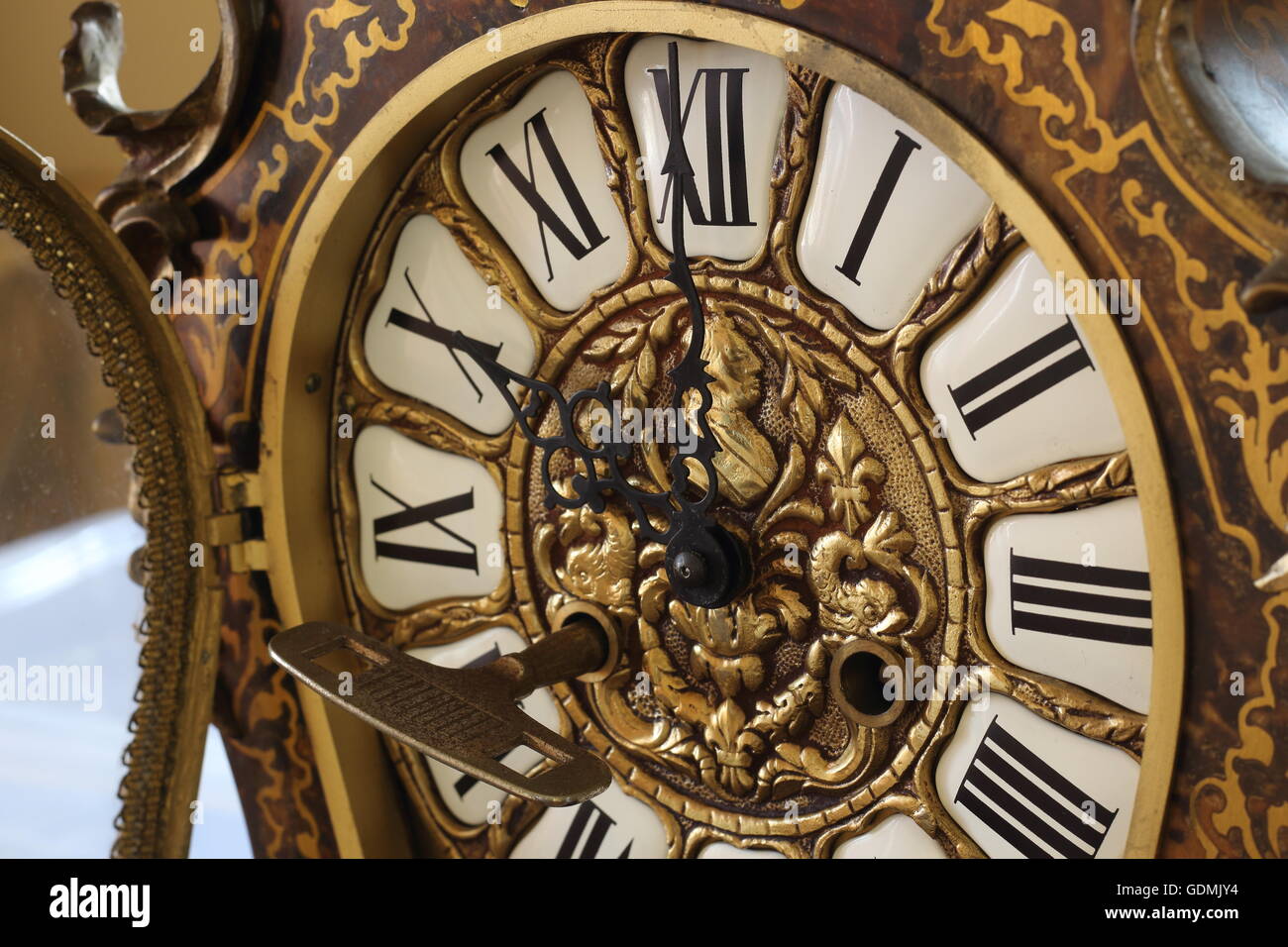 Detail of an old clock with old key winder. Concept of the time. Stock Photo