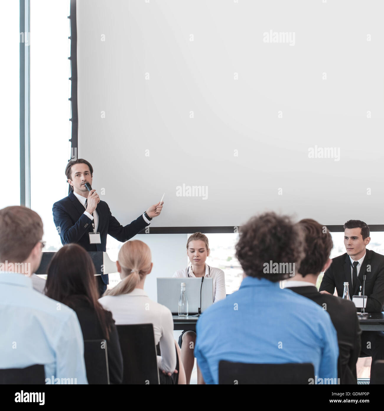 Business people speaking at presentation in microphone in office Stock Photo