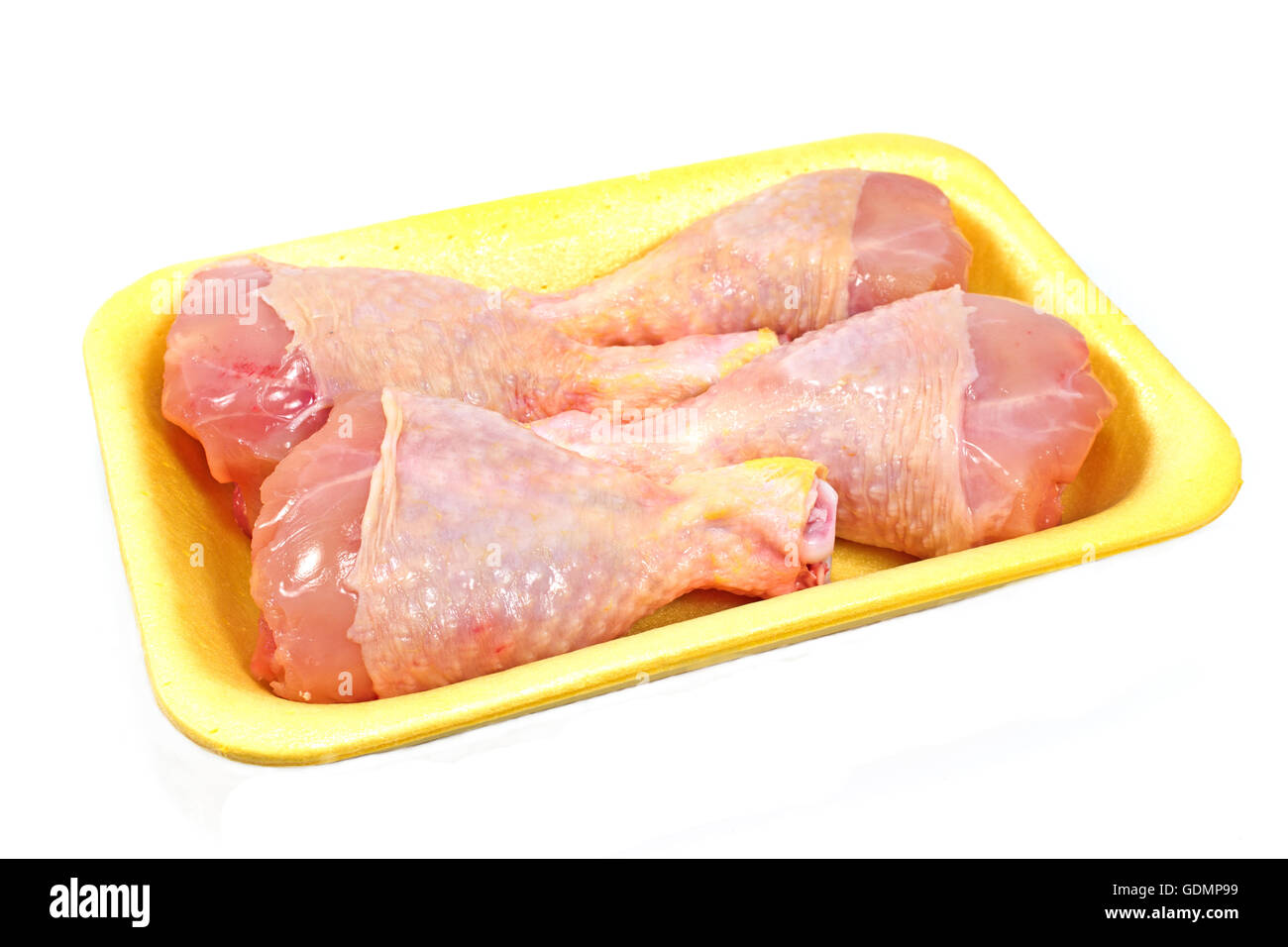Raw chicken legs in plastic bowl isolated on white Stock Photo