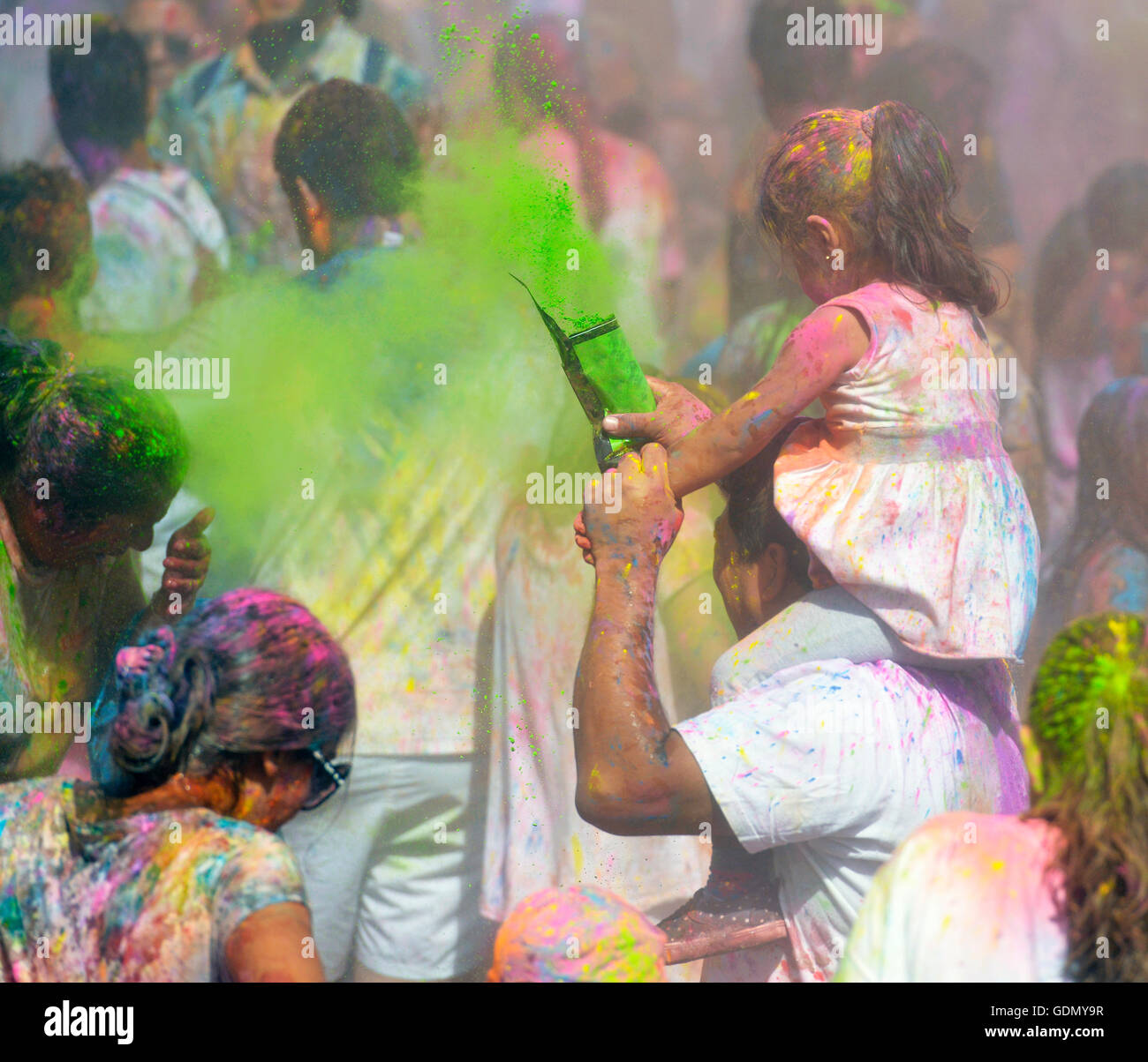 People celebrating during the color throw at the Holi Festival of Colors in Barcelona, Spain. Stock Photo