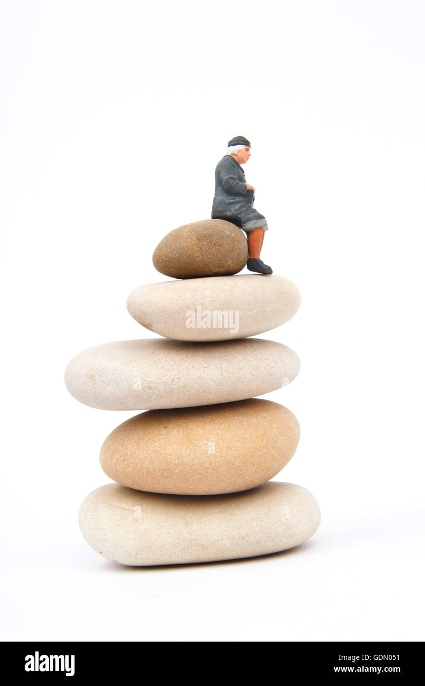 Figurine of an elderly woman on stones Stock Photo