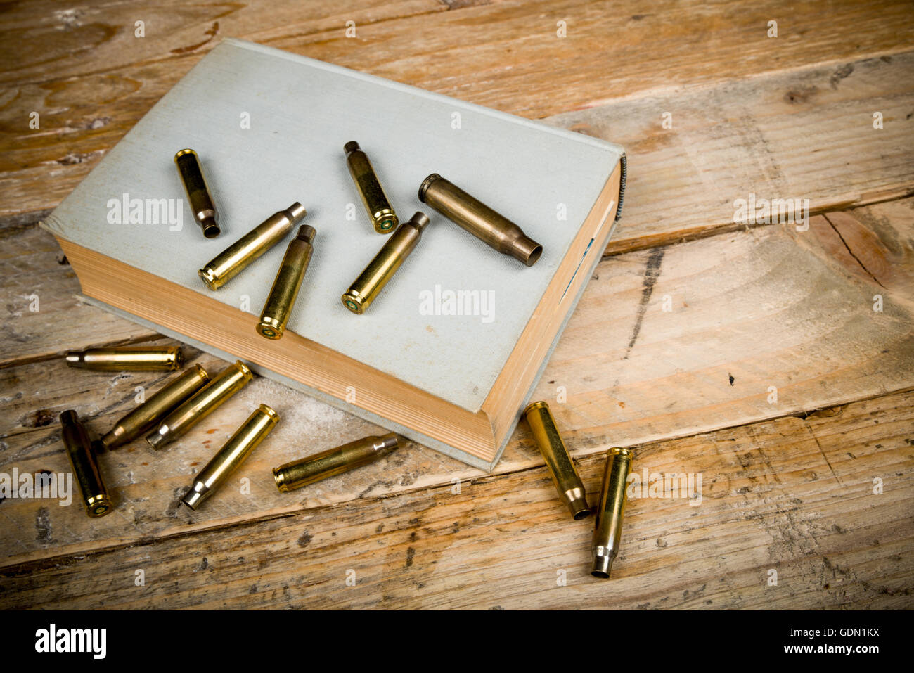 Still life  with old book and bullets, a mystery novel concept Stock Photo