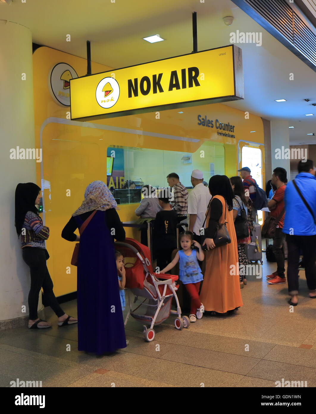 People buy tickets for Nok Air flights at Don Mueang airport in Bangkok Thailand. Stock Photo