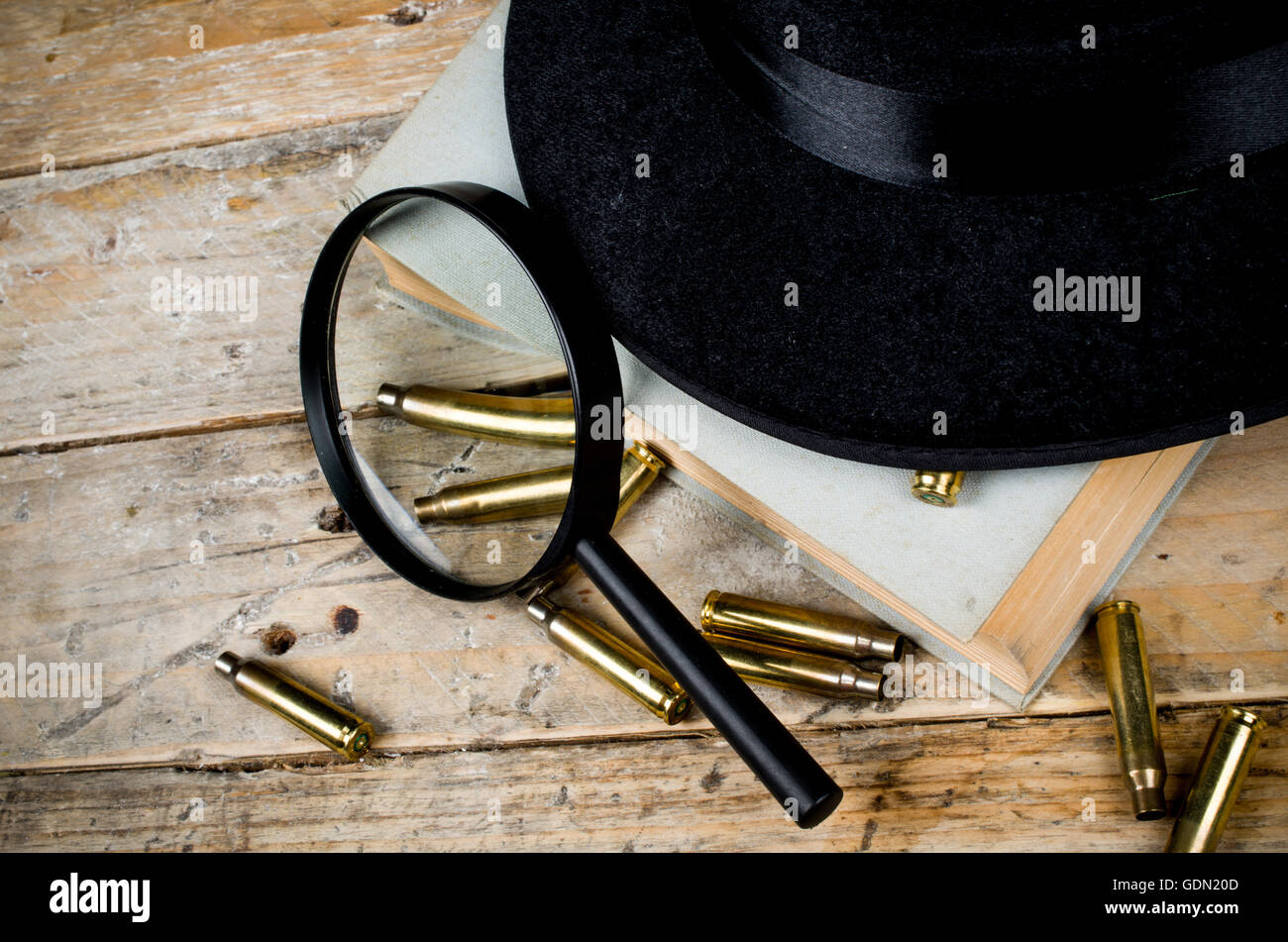 Fedora hat, bullets and magnifying glass, a film noir concept Stock Photo