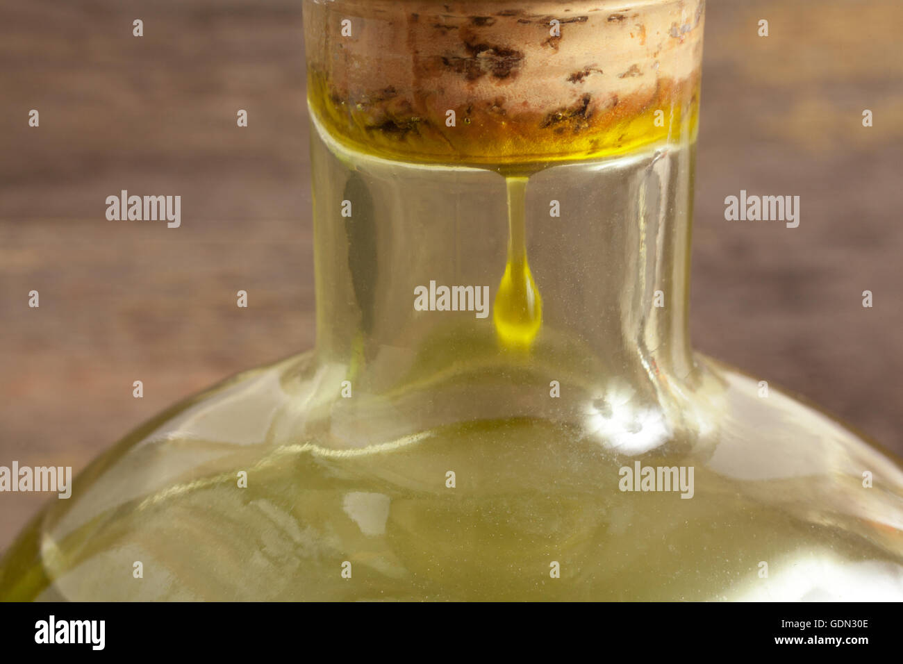 Olive oil bottle on wooden background Stock Photo