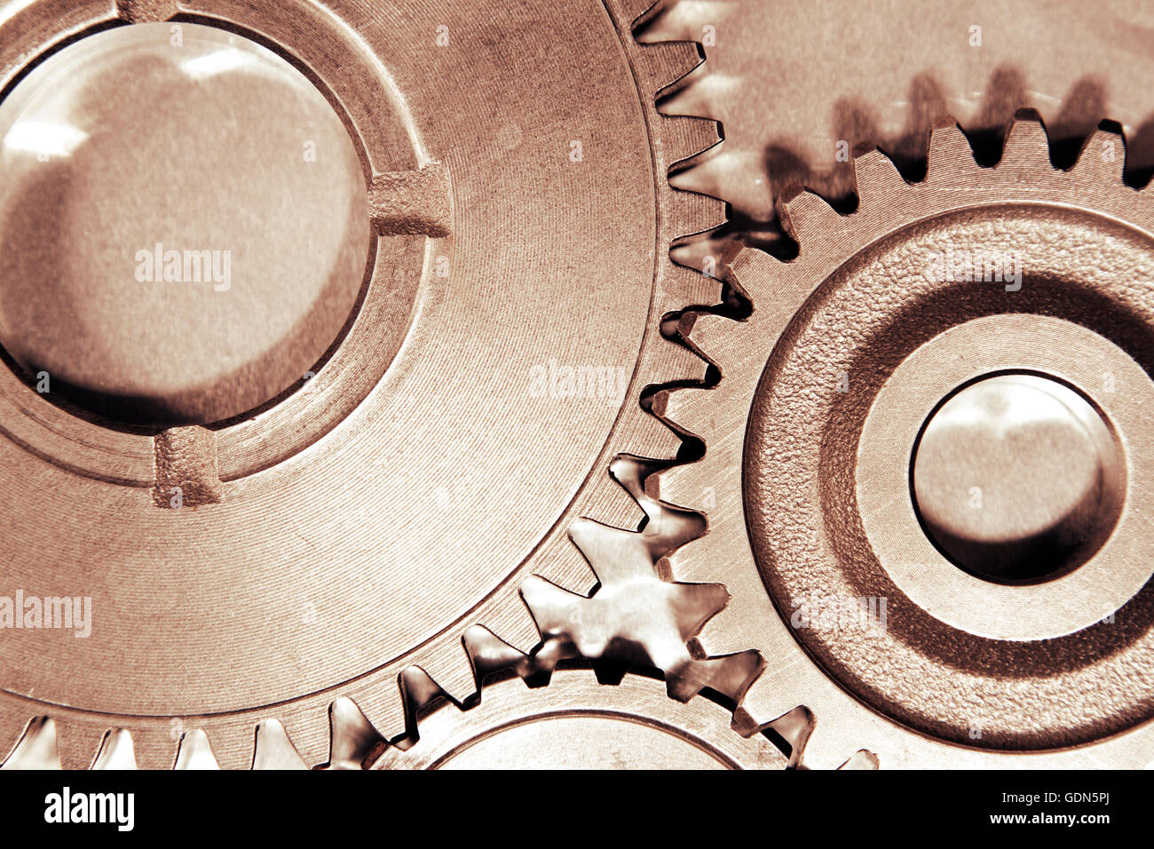 Metal cog gears joining together Stock Photo