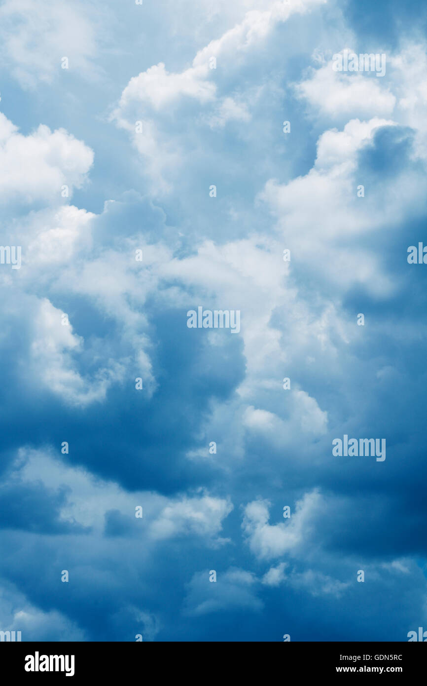 Fluffy clouds in a blue sky Stock Photo - Alamy