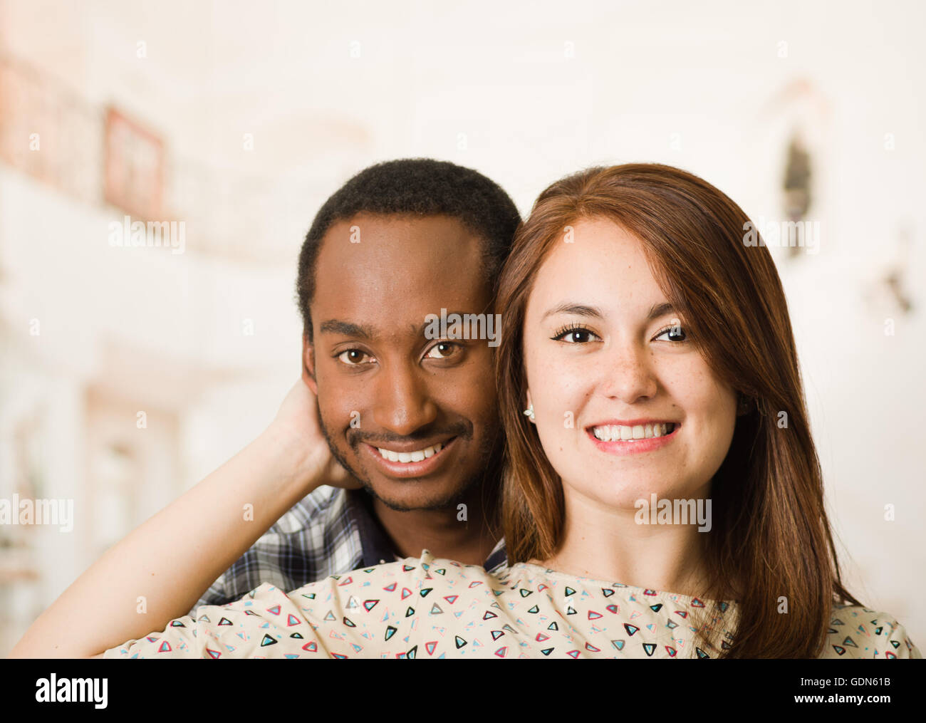 Happy interracial couple headshots posing happily and smiling, woman