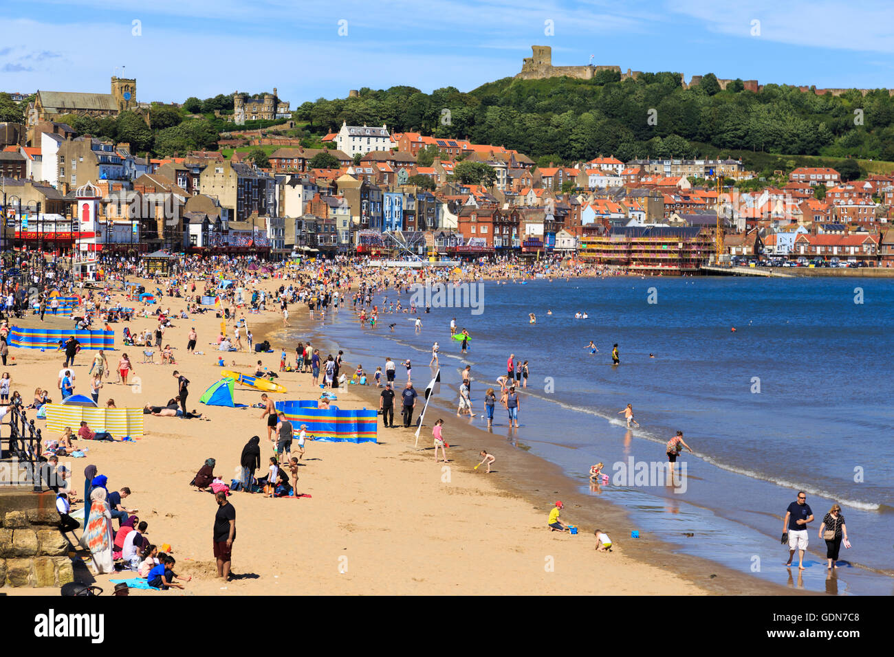 Lots of people enjoying Scarborough beach on a hot summer day. In