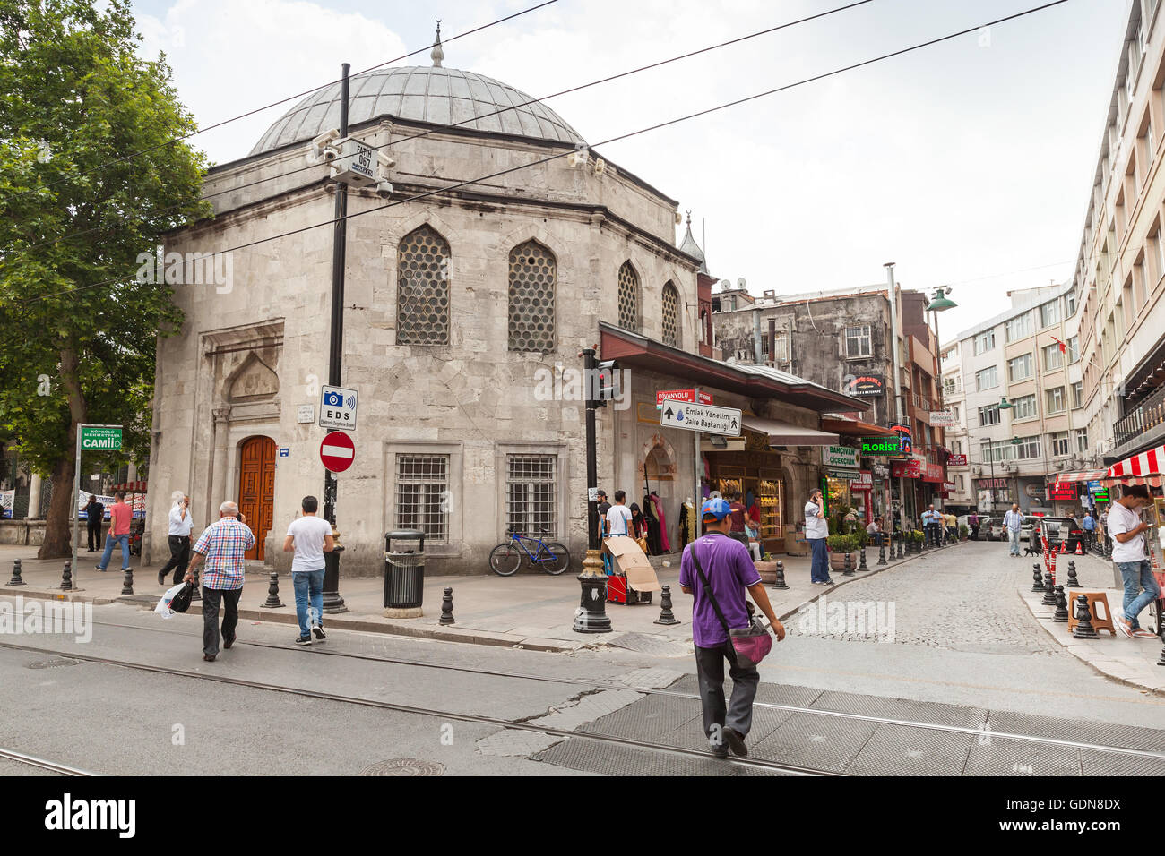 Istanbul, Turkey - June 28, 2016: Ordinary people walk on Istanbul street near Koprulu Mehmet Pasa Mosque Stock Photo