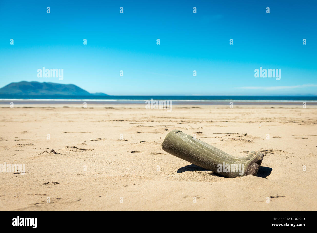 Lost wellington boot on a beach Stock Photo