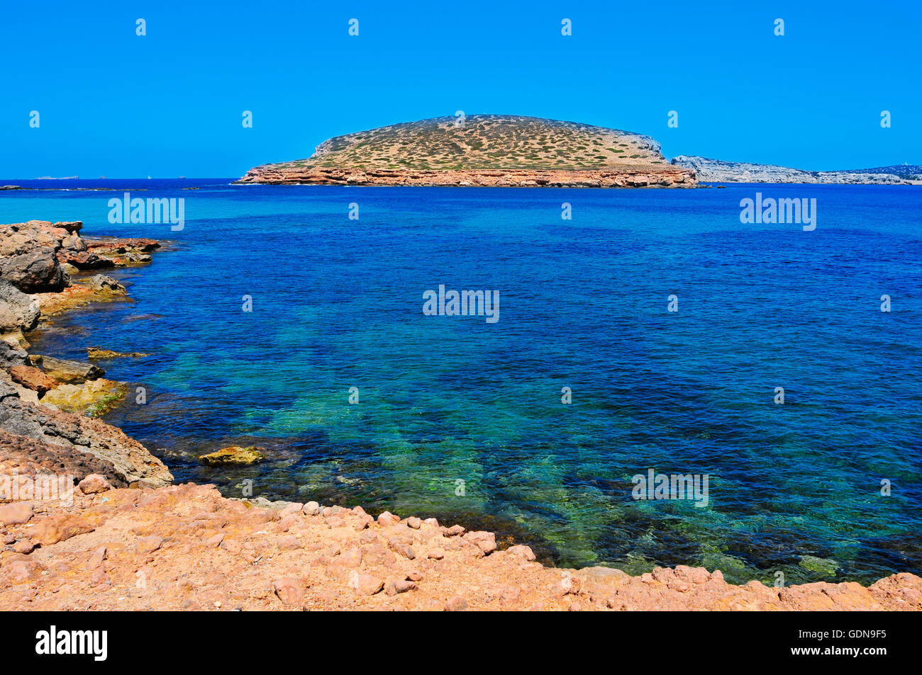 a view of the Southern coast of Sant Antoni de Portmany, in Ibiza Island, Spain, with the Illa des Bosc island in the background Stock Photo
