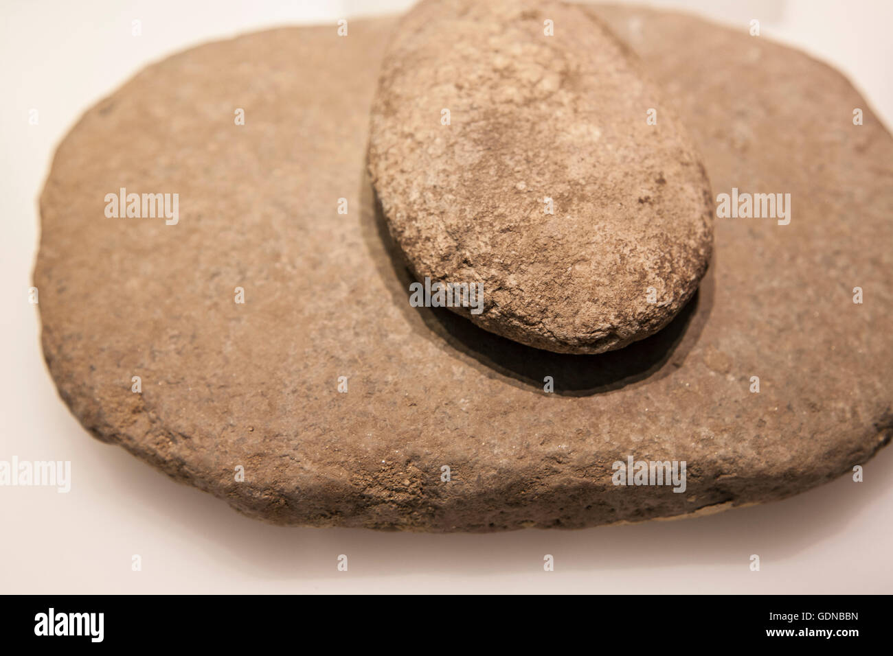 Neolithic era simple mill stone. Selective focus Stock Photo