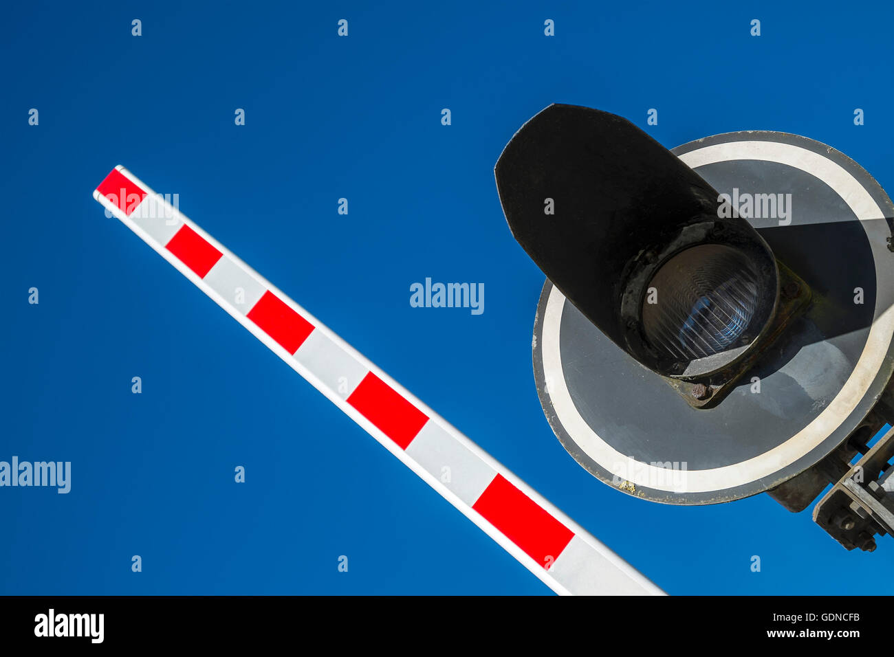 Railway level crossing barrier and light - France Stock Photo