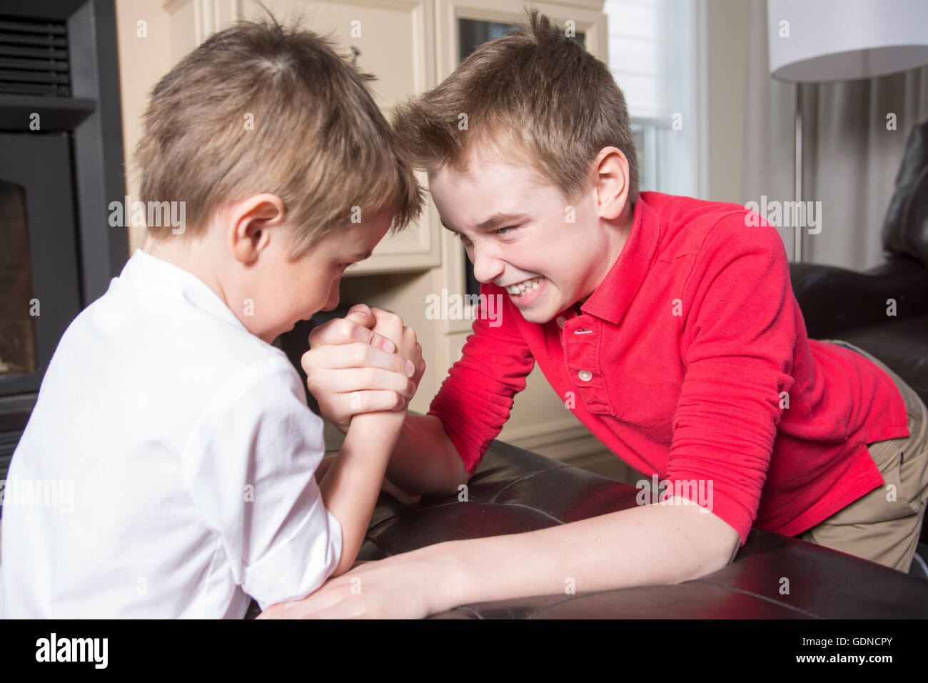 Caucasian brothers arm wrestling hires stock photography and images