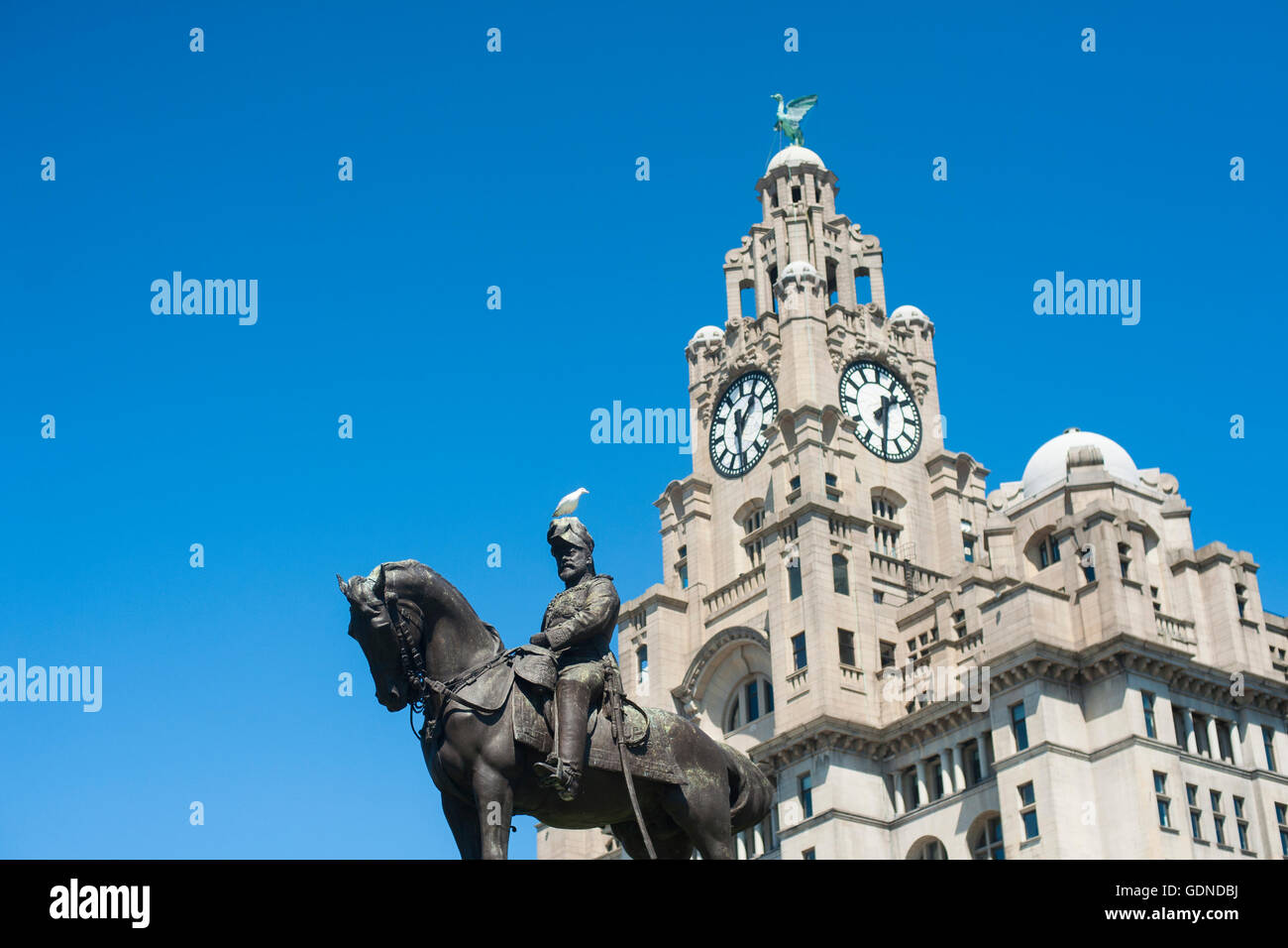 The Liver Building in Liverpool UK with King Edward Vii statue in foreground on a sunny day Stock Photo