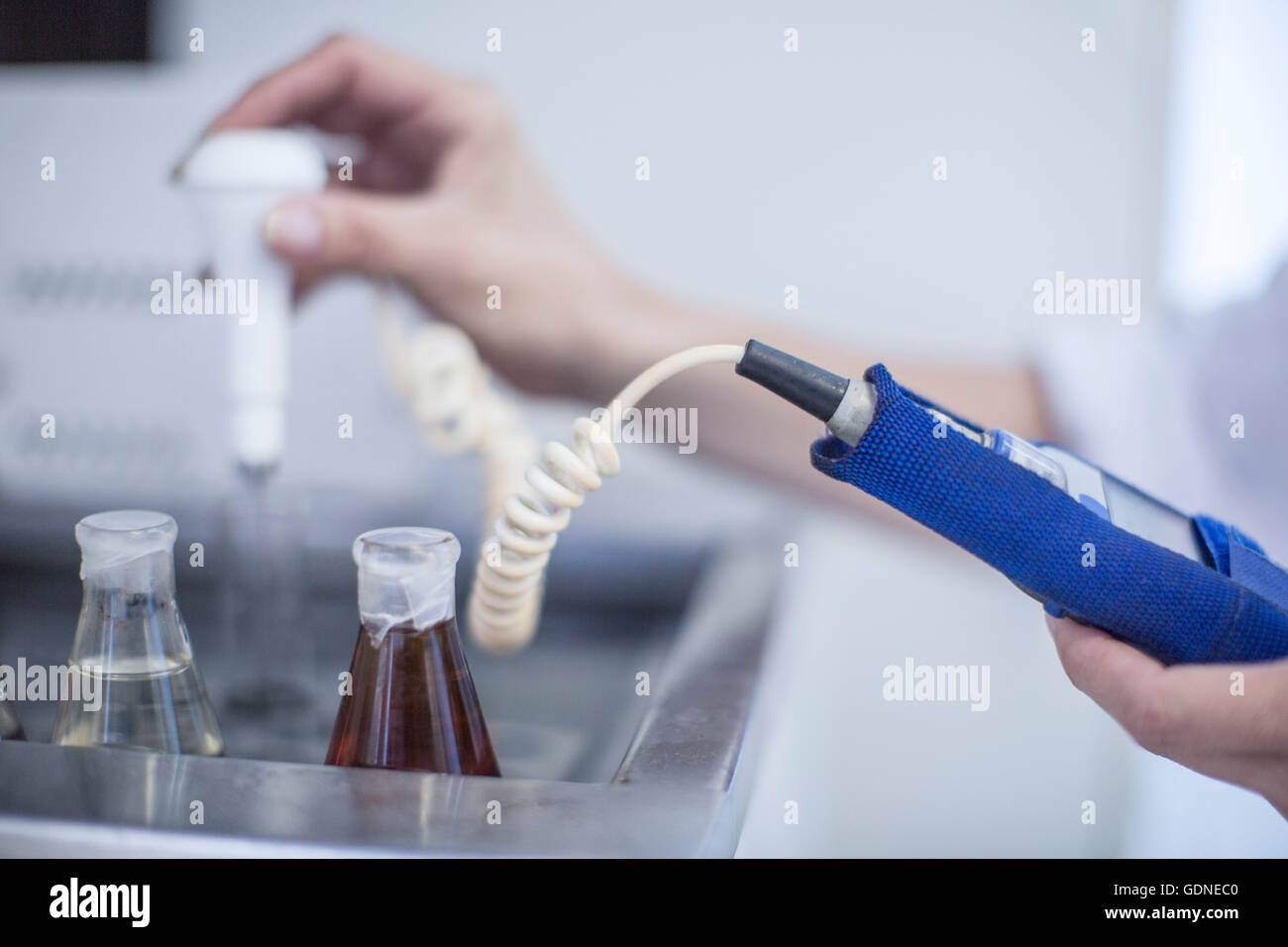Mid adult man using laboratory equipment, close-up Stock Photo