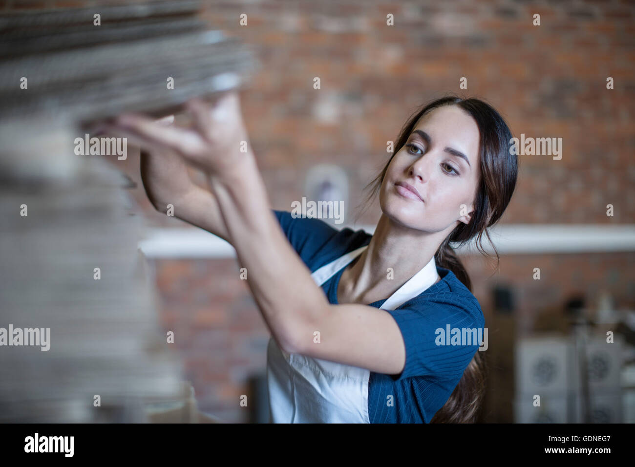 Woman wearing apron hi-res stock photography and images - Alamy