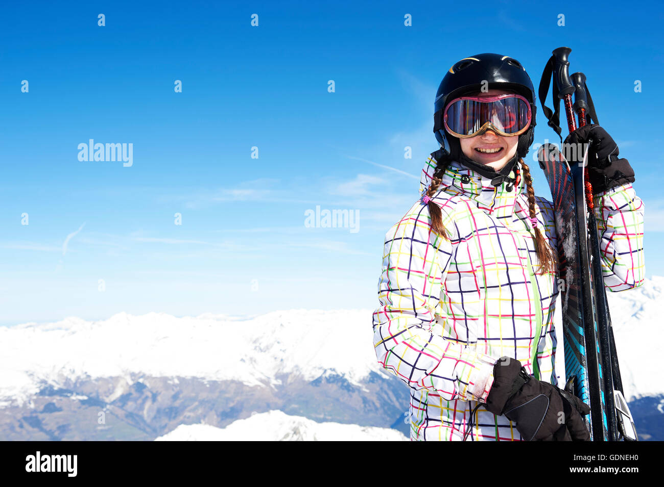 Portrait of teenage girl holding skis Stock Photo