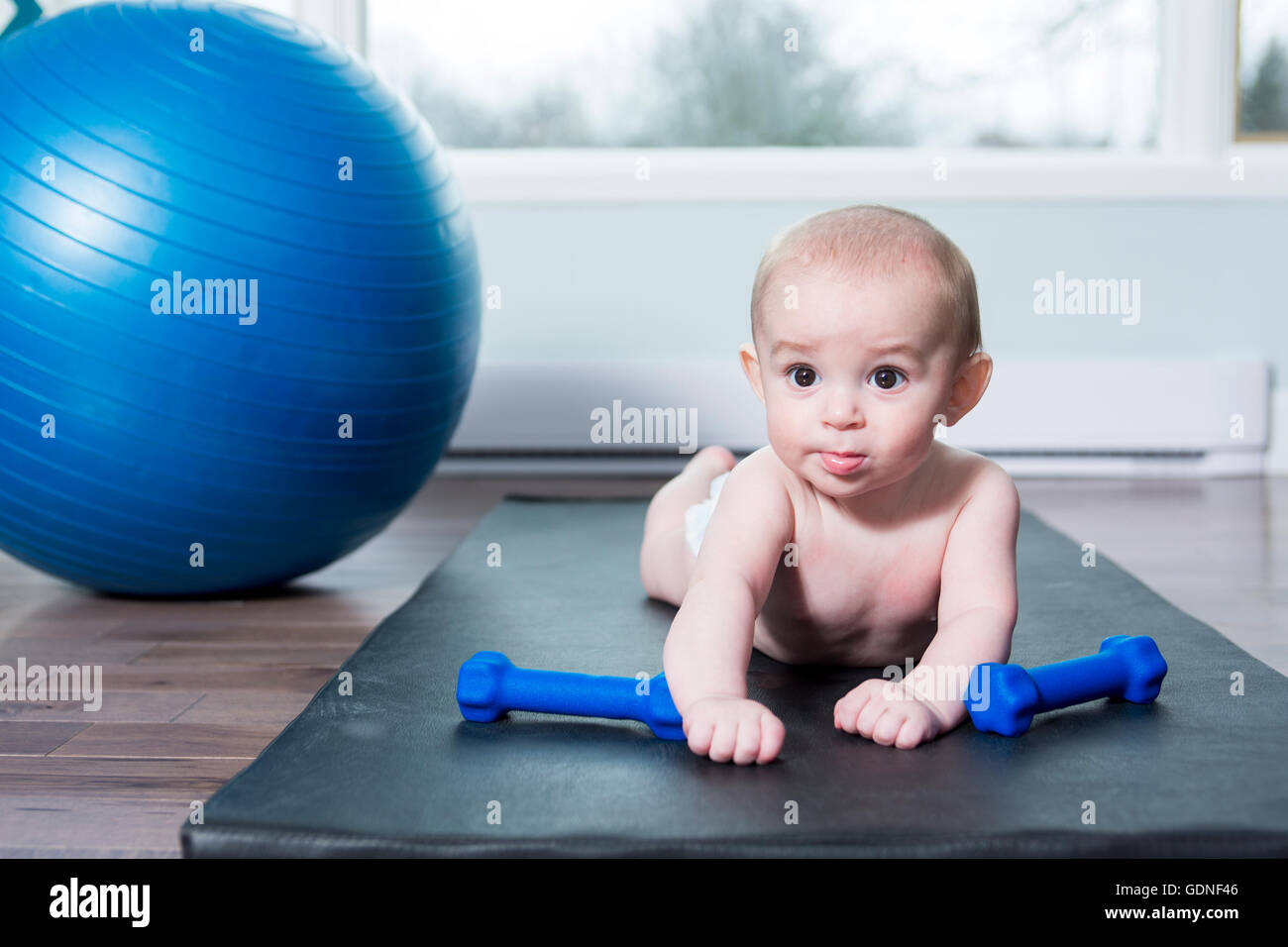 cute baby doing exercises with ball at home Stock Photo Alamy