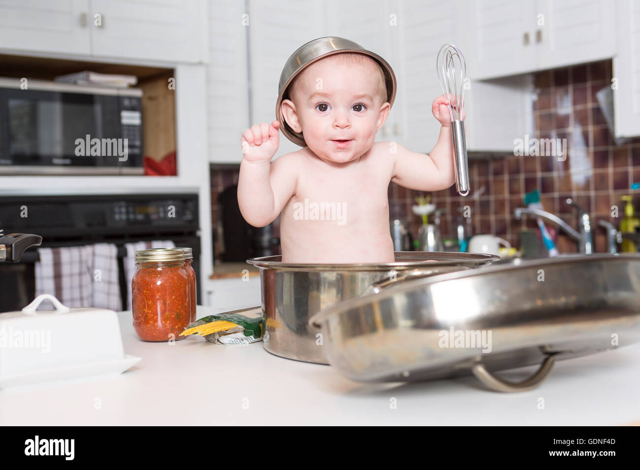 adorable baby cooking in kitchen Stock Photo Alamy
