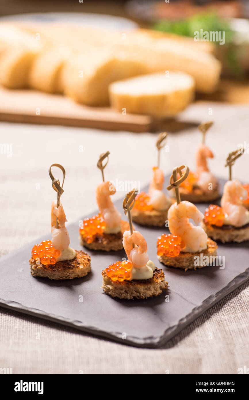 Shrimp Appetizer served on toasted bread with golden Caviar Stock Photo