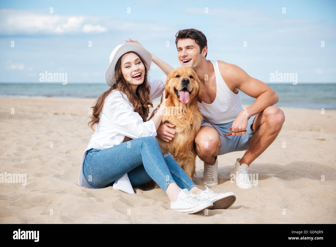 mature nudist couple Young attractive teen couple with a dog sitting on the beach Stock Photo -  Alamy