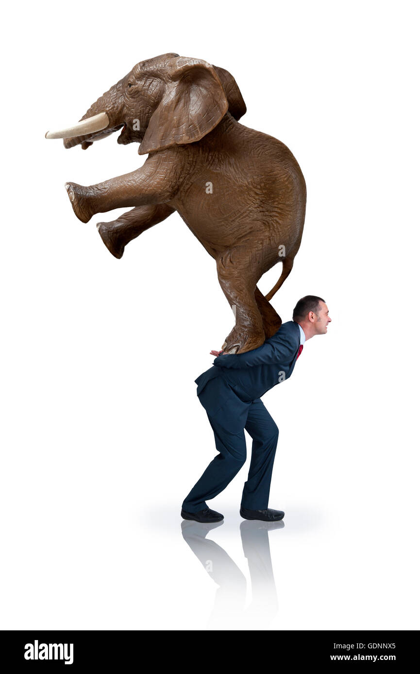 a determined strong businessman carrying an elephant on his back Stock Photo