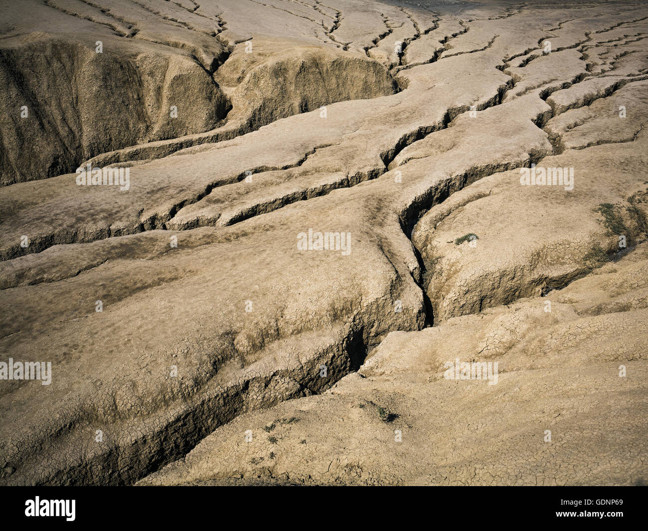 Cracked earth shaped by mud volcanoes Stock Photo