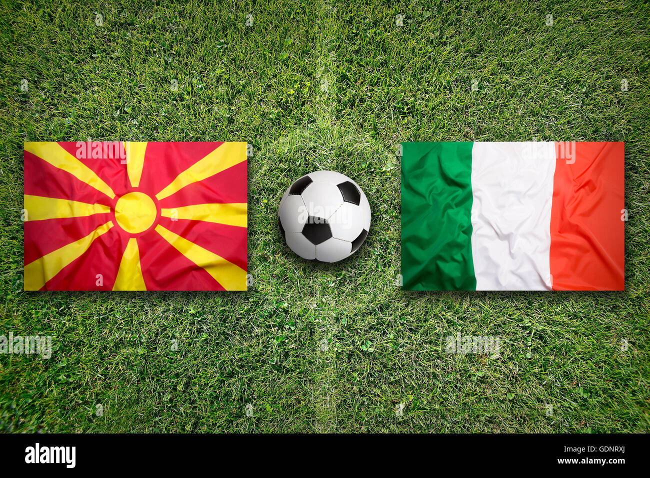 Macedonia vs. Italy flags on green soccer field Stock Photo Alamy