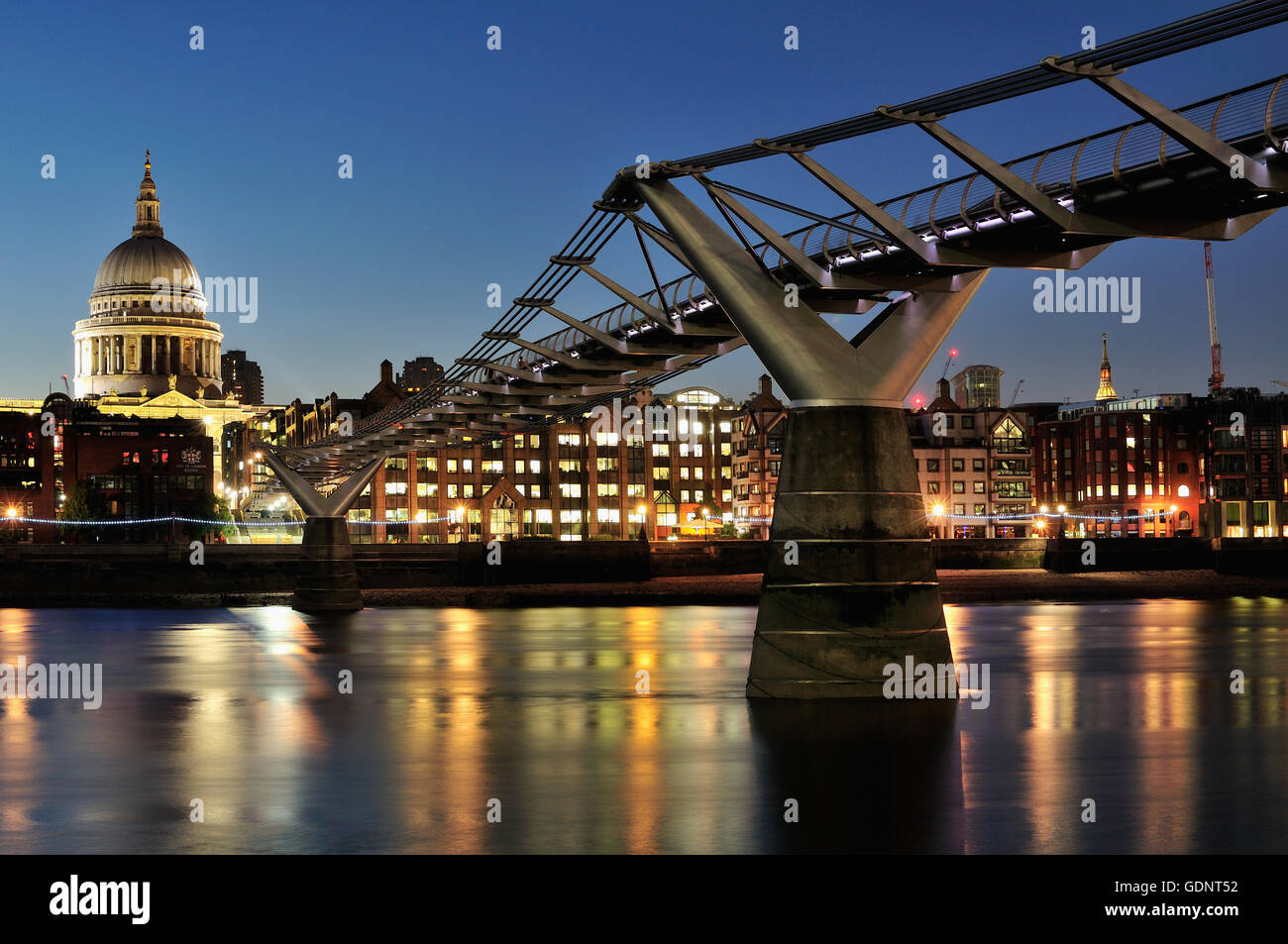 The Milennium Bridge London UK at night, with St Pauls Cathedral Stock Photo