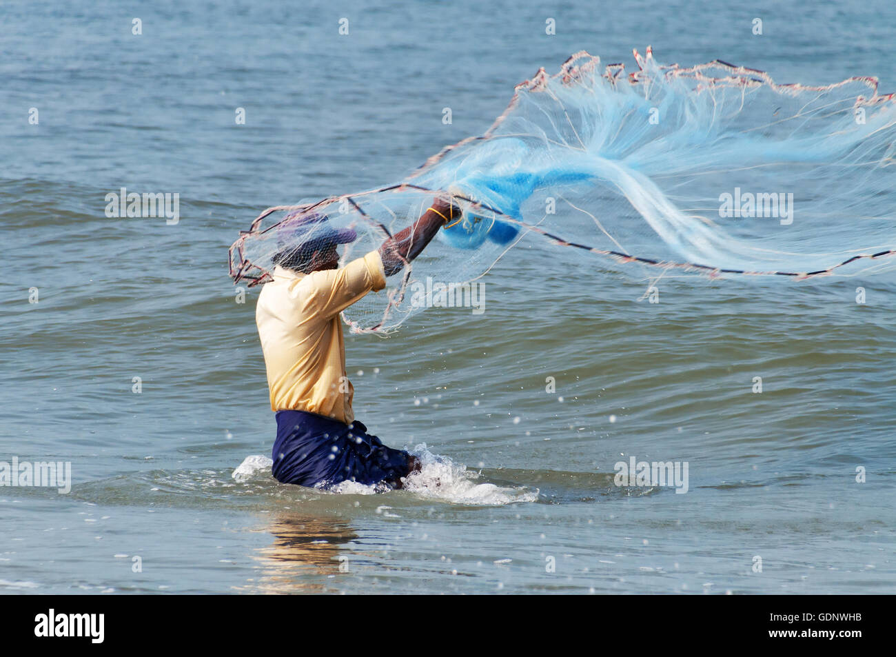 Unidentified Indian fisherman catch fish by throwing net Stock Photo - Alamy