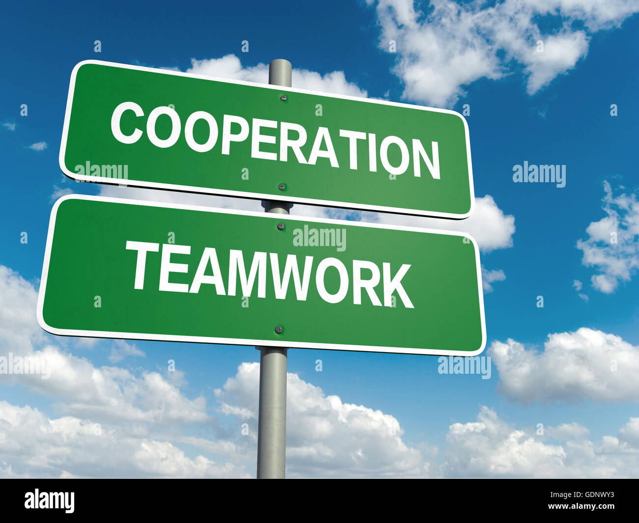 A road sign with cooperation teamwork words on sky background Stock Photo