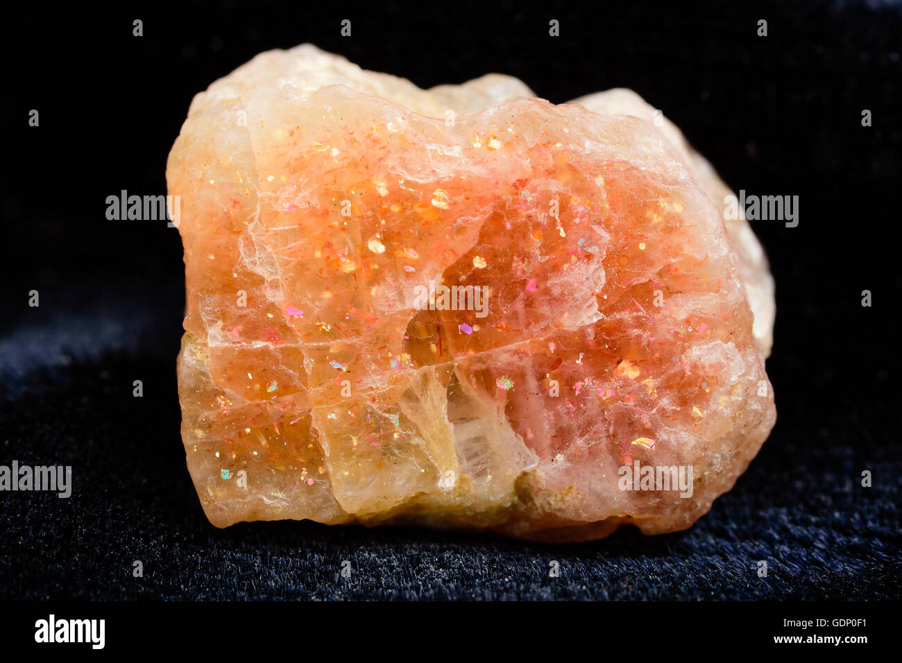 Nice uncut sunstone crystal with copper inclusions. Stock Photo