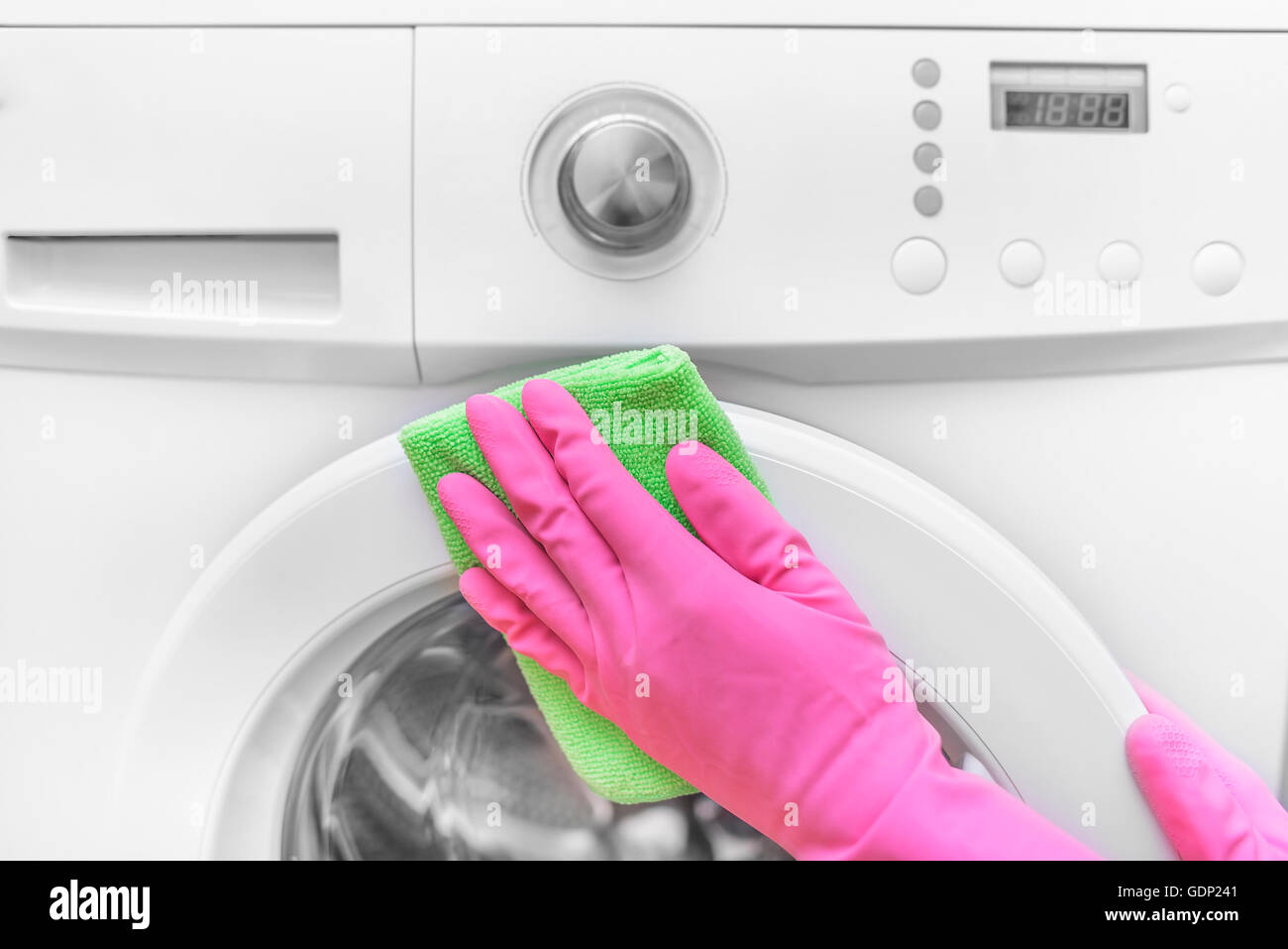 Female hands in gloves washing washing machine. Closeup Stock Photo