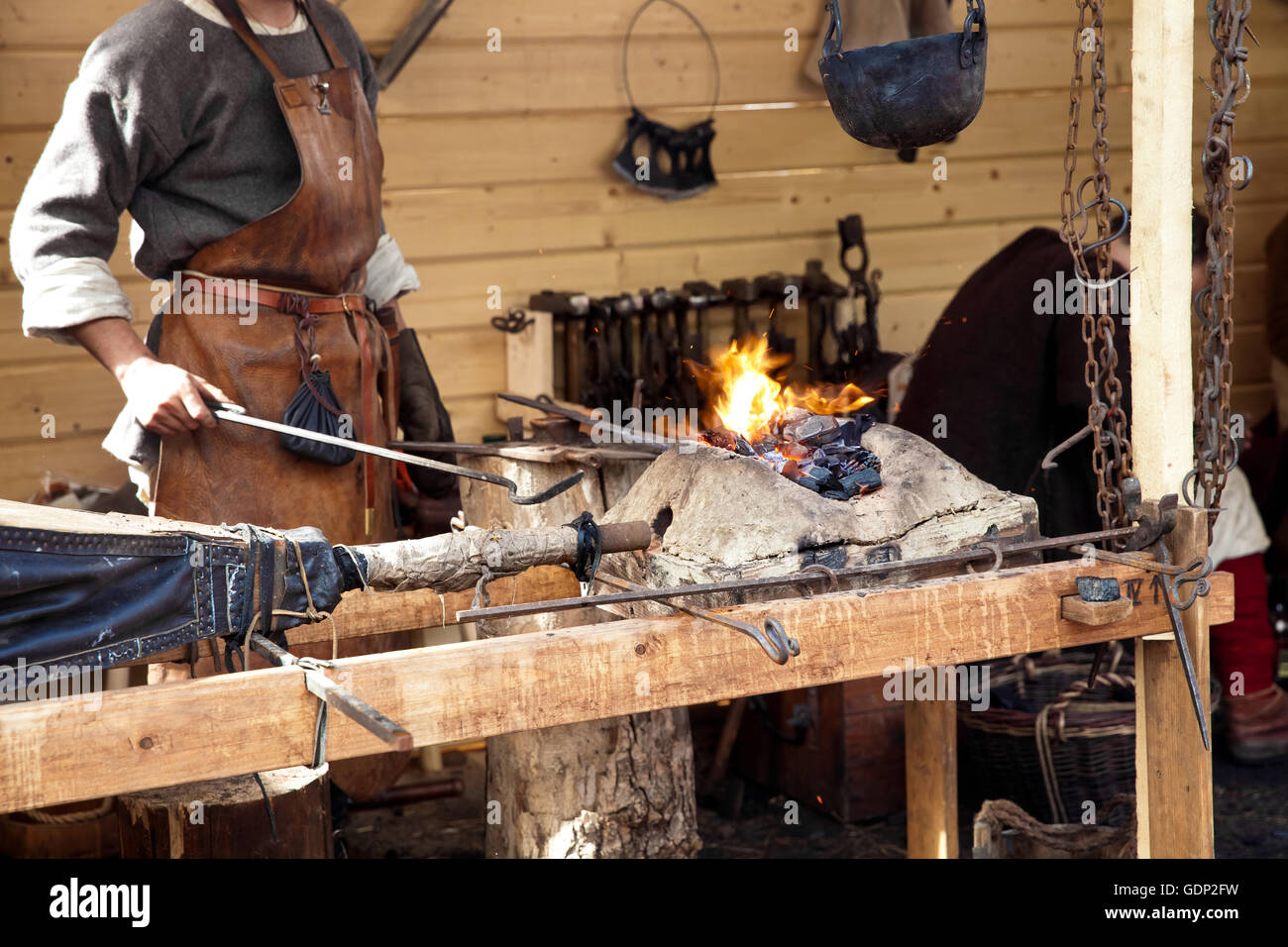 Blacksmith blows the bellows Stock Photo