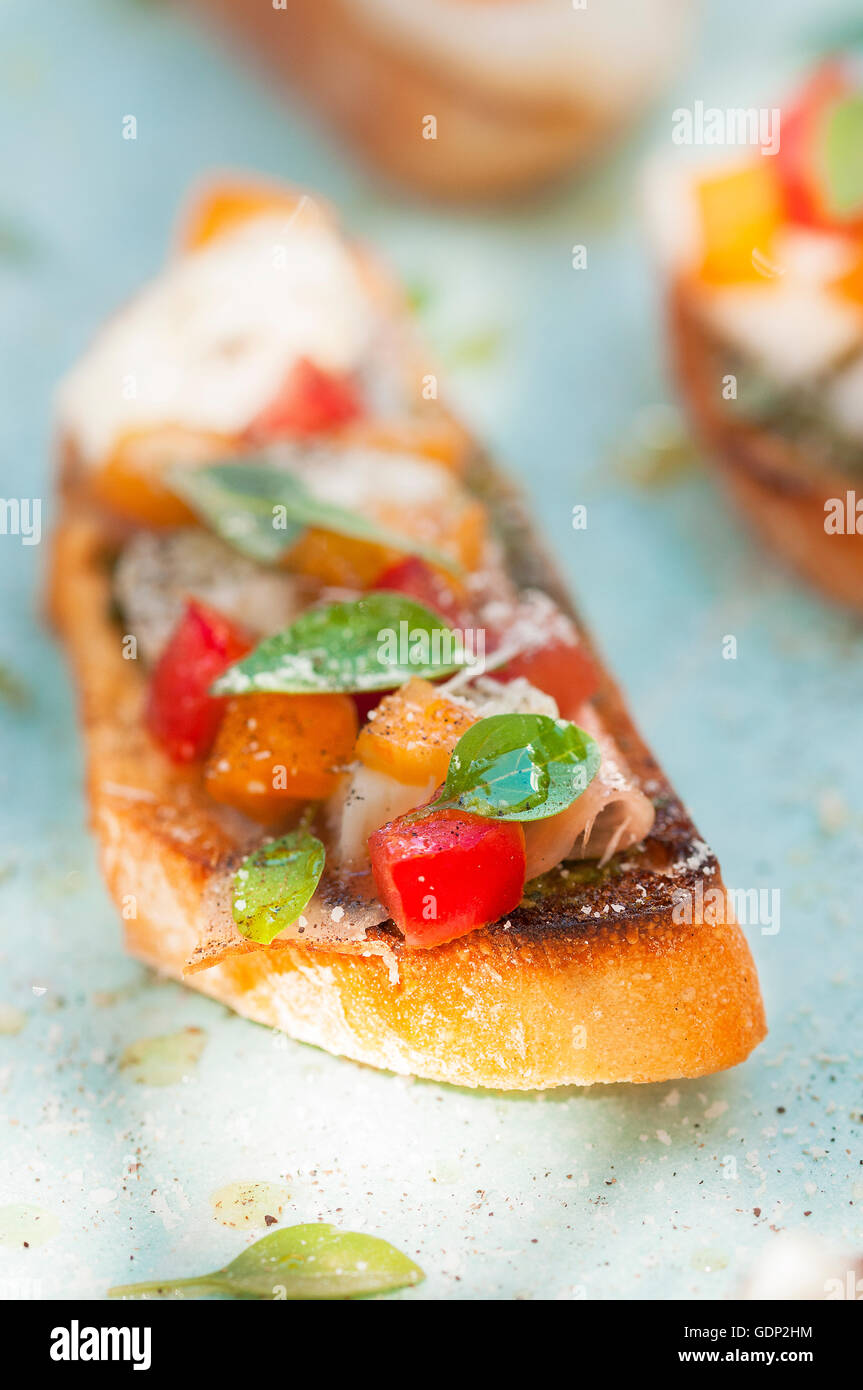 Bruschetta tomatoes with mozzarella and ham in a garden Stock Photo