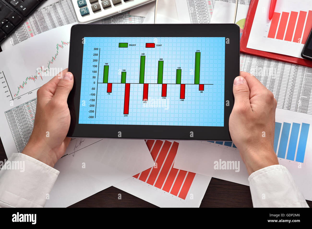 hands holding tablet with cost chart on screen Stock Photo Alamy