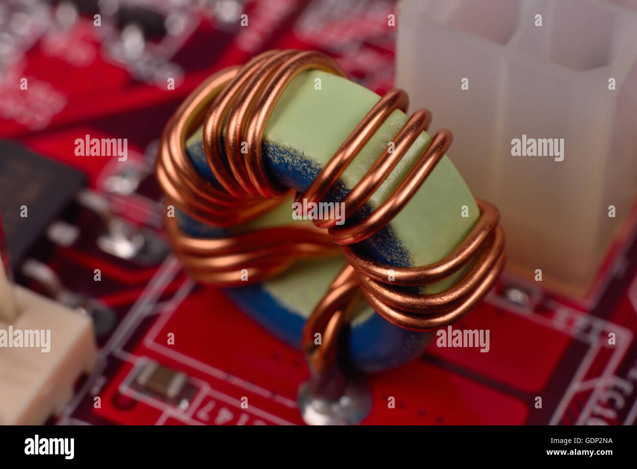 ferrite ring on red circuit board, close up Stock Photo
