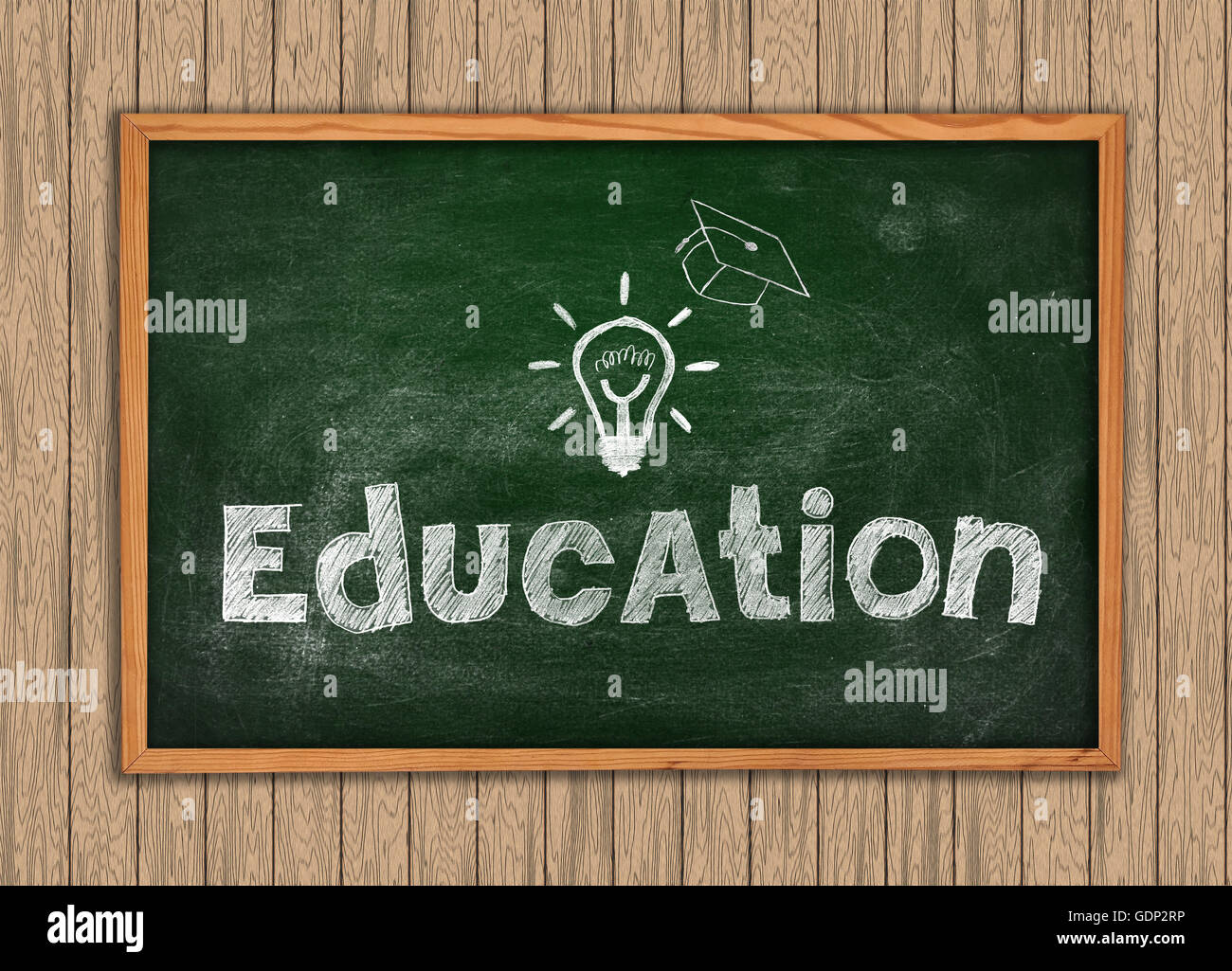 Green Blackboard with drawing education on a wooden wall Stock Photo